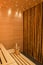 Vertical shot of a beautiful sauna room design with wall tiles and wooden bench