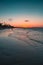 Vertical shot of the the beautiful sunset over the sea and the beach captured in Cumbuco, Brazil