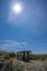 Vertical shot of a bench in a dune at the seaside on a sunny day