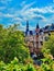 Vertical shot of Berlin Architectures behind trees from a balcony in Germany