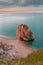 Vertical shot of a big rock by the ocean captured in Begur, Spain