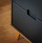 Vertical shot of a black chest of drawers