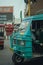 Vertical shot of a blue Rickshaw driving Indian streets