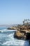 Vertical shot of the blue sea and a rocky shore