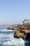 Vertical shot of the blue sea and a rocky shore