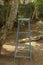 Vertical shot of a blue staircase put next to a tree