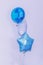 Vertical shot of blue and white balloons in the form of a round circle and star
