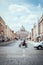 Vertical shot of a blurred motorbiker and the St. Peter`s Basilica in Vatican City