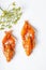 Vertical shot boiled orange crayfish on the white background. Cooked freshwater delicious crayfish with dill. Top view. Copy space