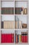 Vertical shot of a bookshelf in a wall filled with literature books and encyclopedias