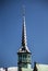 Vertical shot of the Borsen Copenhagen tower with a blue sky in the background in Denmark