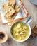 Vertical shot of a bowl of creamy turkey noodle soup served with crispbread with sesame