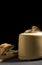 Vertical shot of bread slices on a wooden board with a toaster against a black background