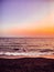 Vertical shot of a breathtaking scenery of the orange skyline and the tranquil ocean