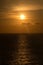 Vertical shot of a bright orange sunset over the Carribean Sea in Cozumel, Mexico