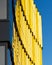 Vertical shot of a bright yellow reflection on a modern mirrored building