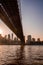 Vertical shot of the Brooklyn Bridge, skyscrapers, and the Hudson River in New York, USA