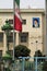 Vertical shot of a building next to the flag of Iran