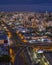 Vertical shot of buildings surrounded by lights at night in Santo Domingo, the Dominican Republic