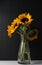 Vertical shot of a bunch of sunflowers in a glass vase on the table in the dark background