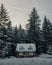 Vertical shot of a cabin in a snowy forest in Washington