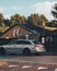 Vertical shot of a car driving against the house