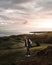 Vertical shot of a Caucasian blond guy walking on the shore on a cloudy day