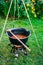Vertical shot of a cauldron with beef goulash soup in a garden