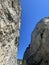 Vertical shot of cave rocks against a blue sky