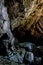 Vertical shot of cave rocks covered with moss