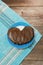 Vertical shot of a chocolate covered pretzel, shaped like a heart, on a plate