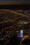 A vertical shot of the city of Bogota at dusk from Monserrate, with night lights and the Colpatria skyscraper on the lower side of