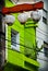Vertical shot of city lamps in front of a green apartment building, aesthetic wallpaper