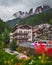 Vertical shot of a cityscape with apartment buildings and high rocky mountains in the background