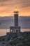 Vertical shot of a classic Punta Nariga lighthouse in Galicia, Spainduring sunset