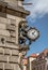 Vertical shot of a clock and a lion statue on a building in Klodzko, Poland