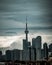 Vertical shot of The CN Tower under a stormy sky in Toronto, Canada
