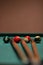Vertical shot of colorful billiard balls and cue sticks on billiard table