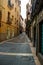 Vertical shot of colorful buildings in an alleyway in Xativa, Spain