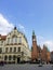 Vertical shot of colorful buildings and a tower in Warsaw Town Hall, Poland