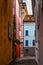 Vertical shot of colorful houses lined along a picturesque cobbled alley, Switzerland