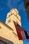 Vertical shot of a Croatian flag waving in the wide beneath a church tower in the old city of Dubrovnik. Proud ancient Croatian