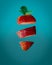 Vertical shot of cut strawberry on an aquatic blue background