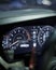 Vertical shot of the dashboard cluster of a car, showing the various gauges and dials