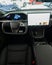 Vertical shot of the dashboard of a Tesla Model S Plaid. steering yoke, car running