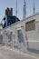 Vertical shot of a deck of a white and blue ferry under a clear blue sky