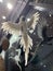 Vertical shot of a decorative white parrot figure hung from a ceiling