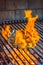 Vertical shot of a delicious appetizing steak cooking over fire flames