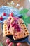 Vertical shot of delicious chicken and waffles with strawberry jam