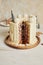 Vertical shot of a delicious Christmas cake with gingerbread decorations and coconutâ€“almond ball